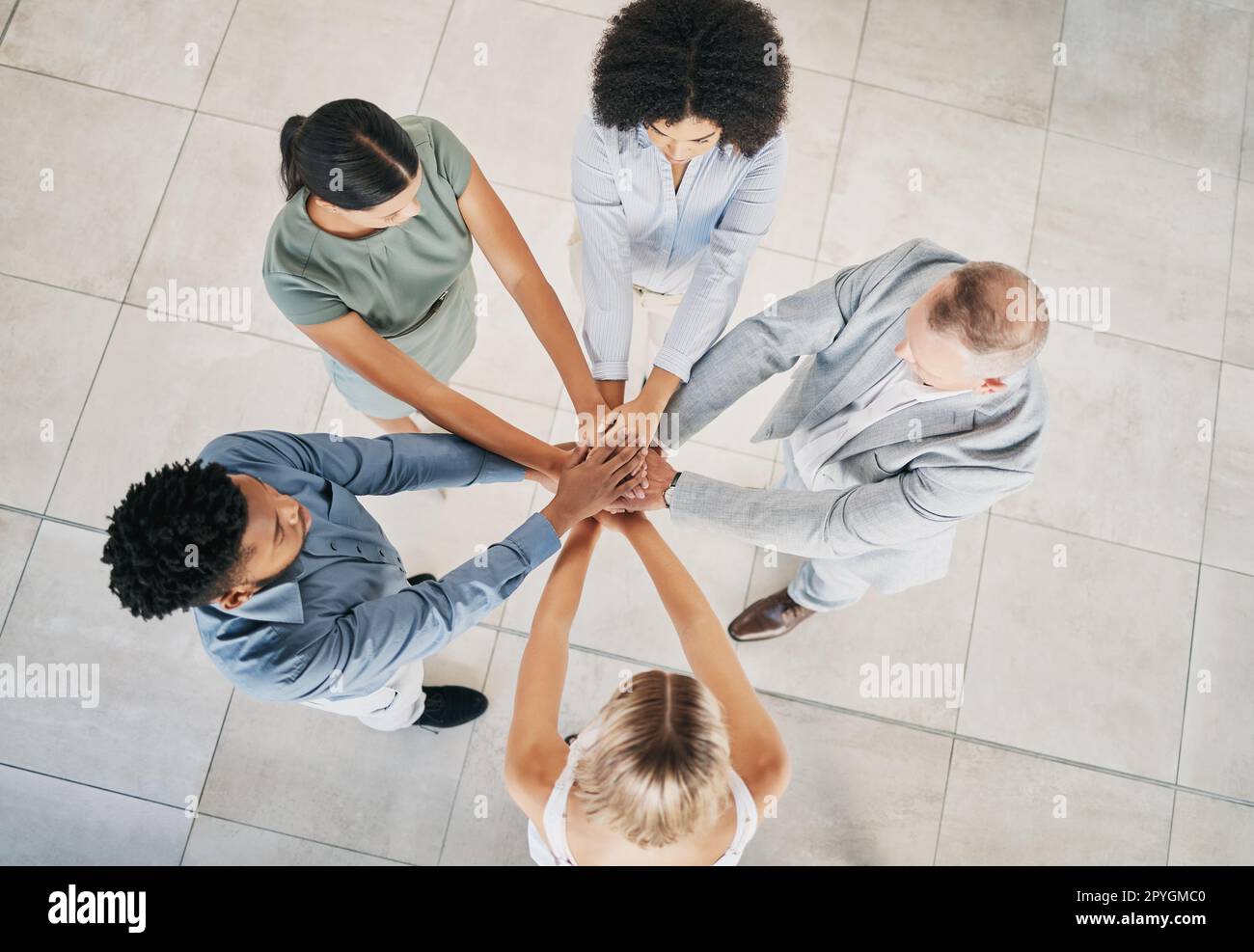 Office, business people and top view of a stack of hands for celebration, motivation or team building. Collaboration, diversity and overhead of a corporate team cheering for teamwork in the workplace Stock Photo