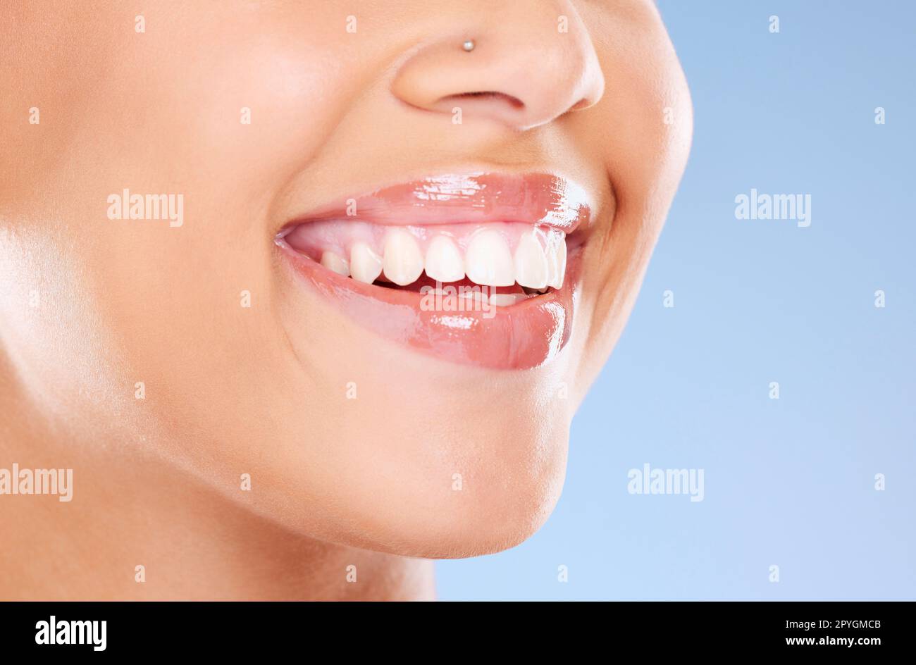 Teeth, mouth and beauty with woman and smile, dental care and Invisalign with teeth whitening and lips against studio background. Face, healthy skin and veneers with cosmetic care and lip filler zoom Stock Photo