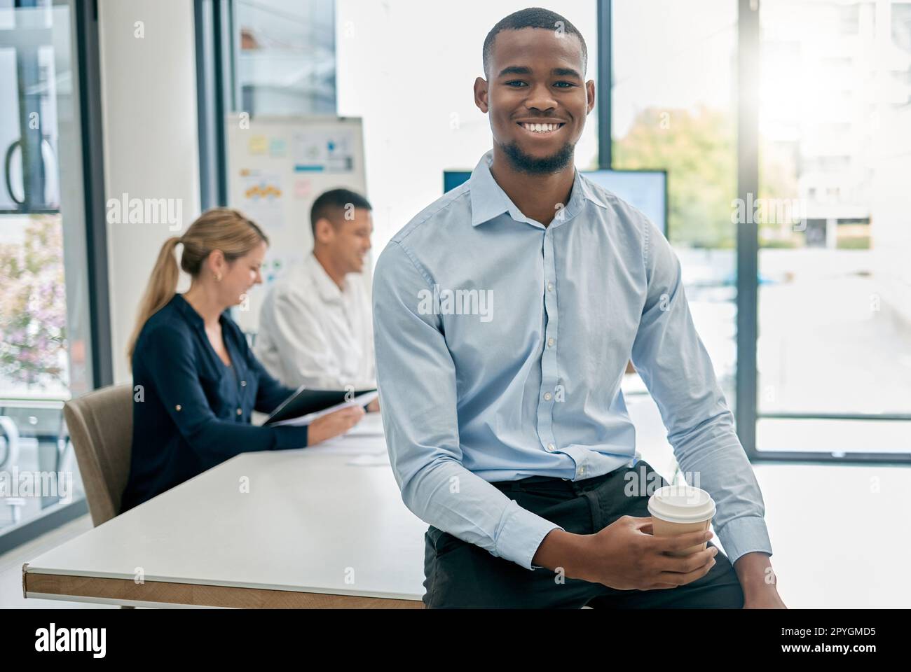 Face portrait, leadership and black man in meeting ready for goals or targets. Ceo, boss and young, happy and confident male entrepreneur with vision, mission and success mindset in company workplace Stock Photo