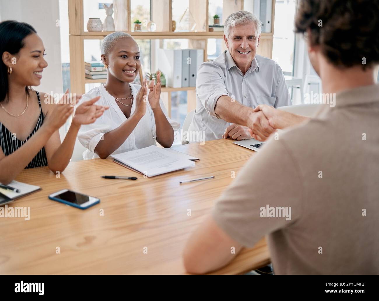 Business people, meeting and applause for handshake, ceo or black woman in office for promotion. Corporate team, shaking hands and congratulations for partnership, collaboration or success in startup Stock Photo