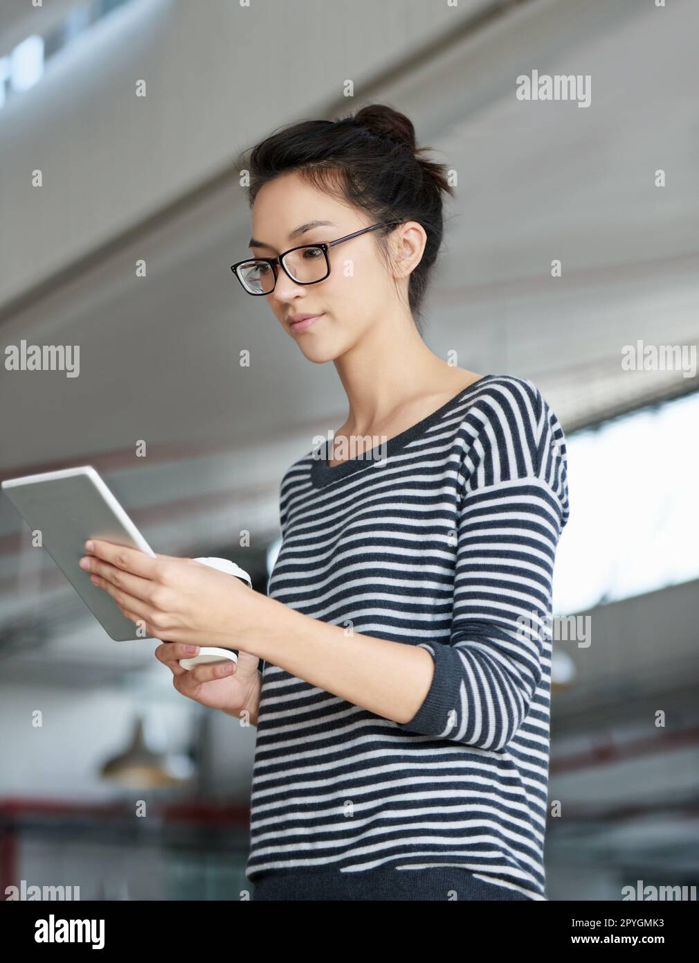 Doing some online research. a young designer at work with a digital tablet. Stock Photo