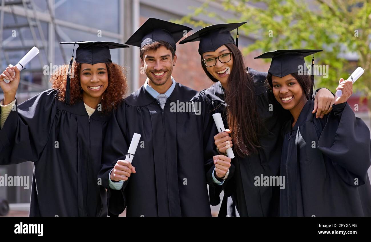 Diplomas in diversity. a diverse group of university students holding their diplomas. Stock Photo
