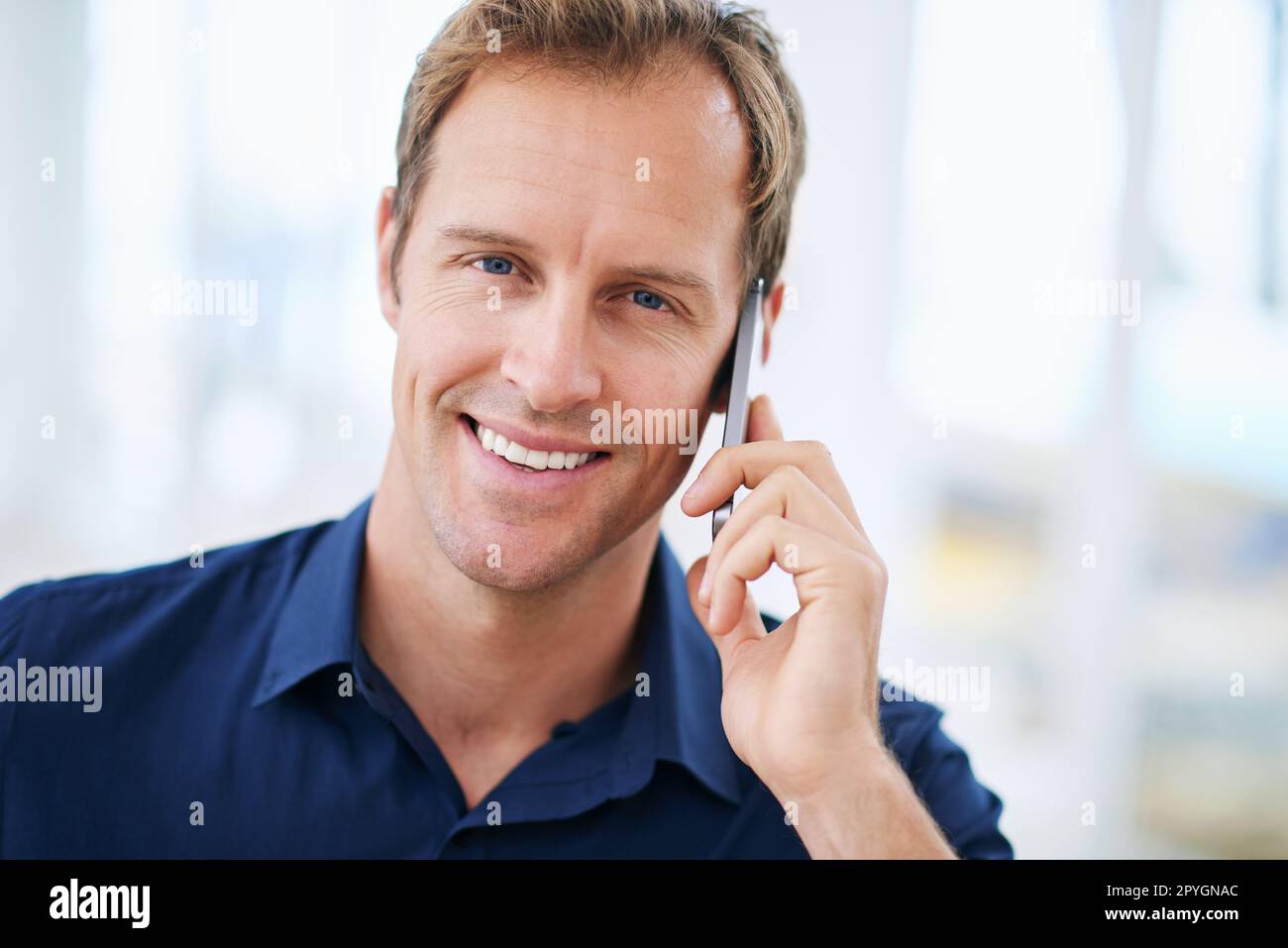 Weekend vibes. a handsome man talking on the phone at home. Stock Photo