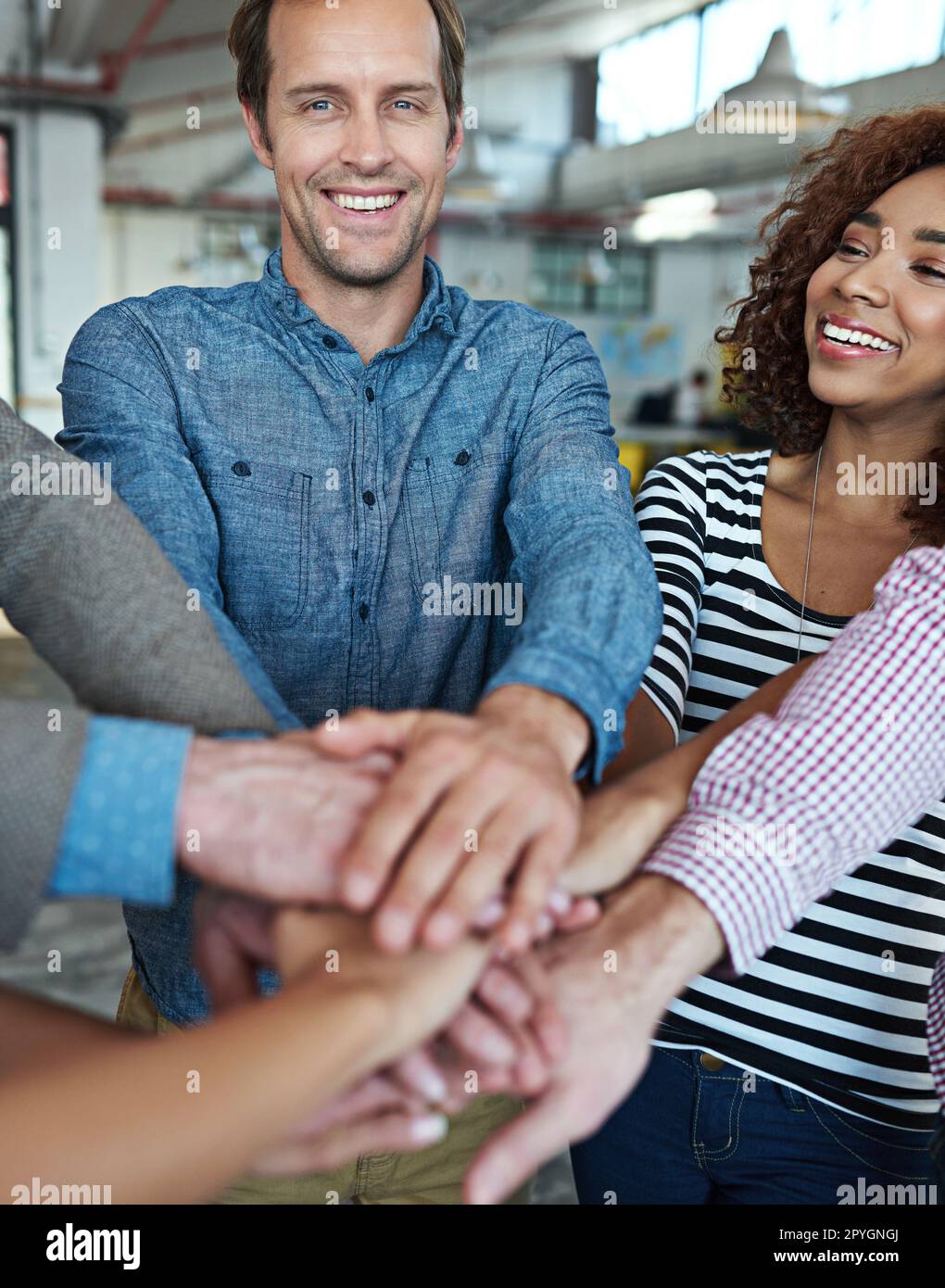 We can do anything as a team. co-workers hand put together in an expression of unity and team spirit. Stock Photo