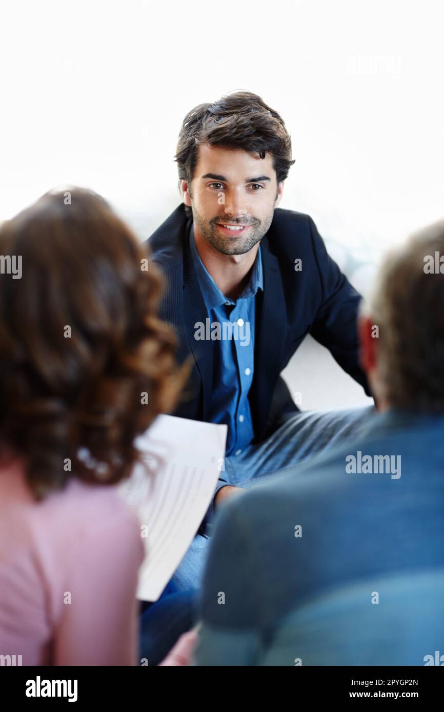Giving them great financial advice. A young consultant giving advice to a mature couple. Stock Photo