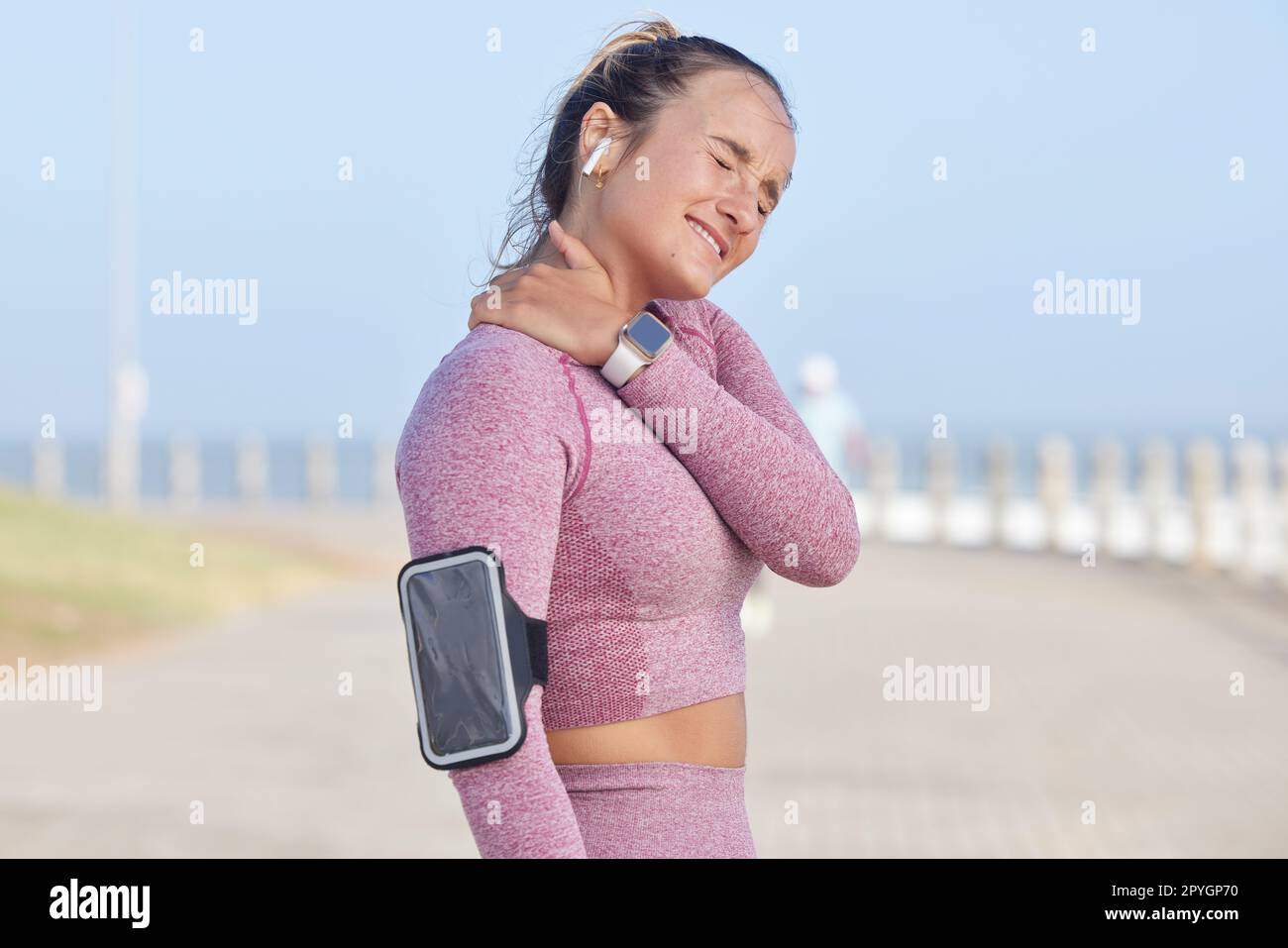 Fitness runner, injury and woman with neck pain problem from workout, outdoor running or exercise. Sky, athlete training accident or sports girl with muscle strain, medical crisis or health emergency Stock Photo