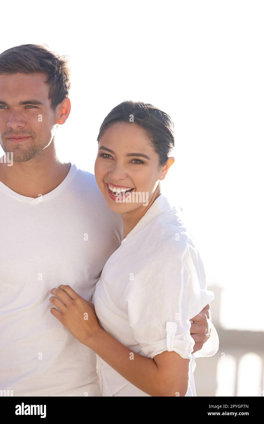 Hanging out with someone special in the sun. an attractive young couple dressed in white Stock