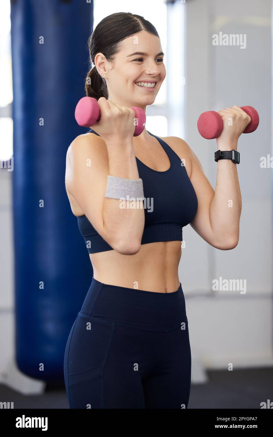 Beautiful healthy happy smiling black asian woman with dumbbell