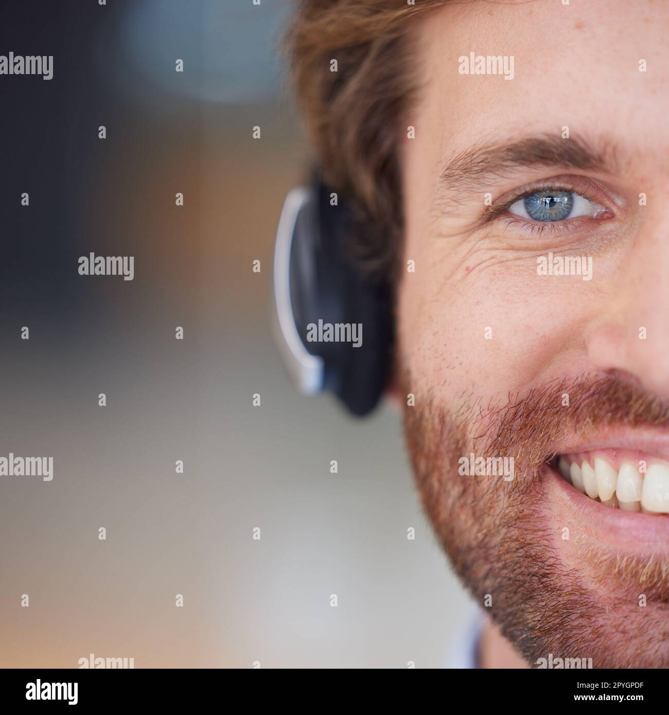 Call center man, closeup and smile in portrait for customer service, happy and focus with headphones. Customer support, crm expert and happiness in zoom of face, eye and telemarketing job in Orlando Stock Photo