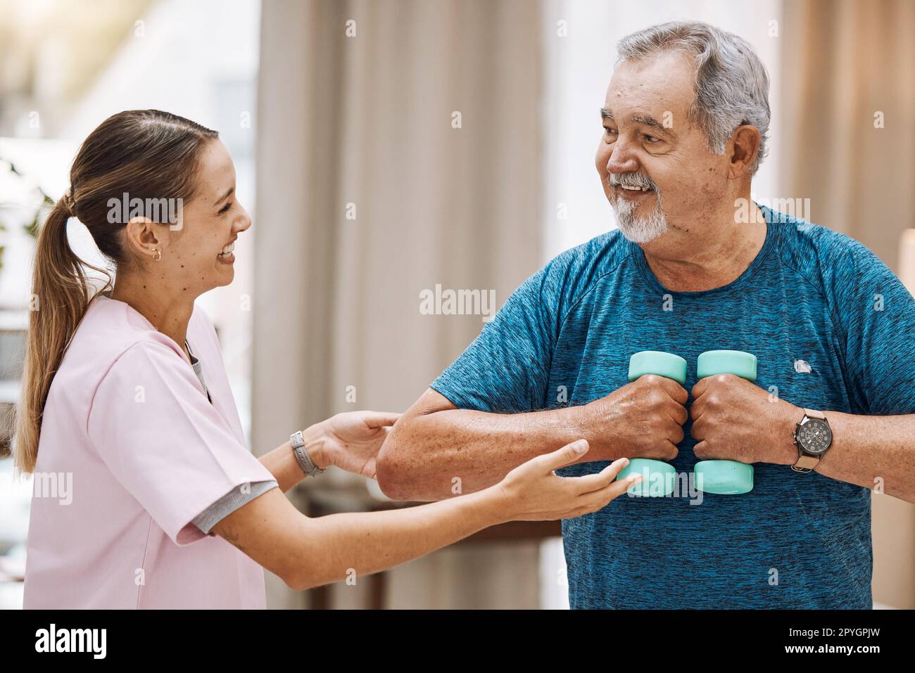 Exercise, physiotherapy and senior man with a physiotherapist for healthcare training, rehabilitation and fitness support. Strength training, workout and doctor with motivation for elderly patient Stock Photo