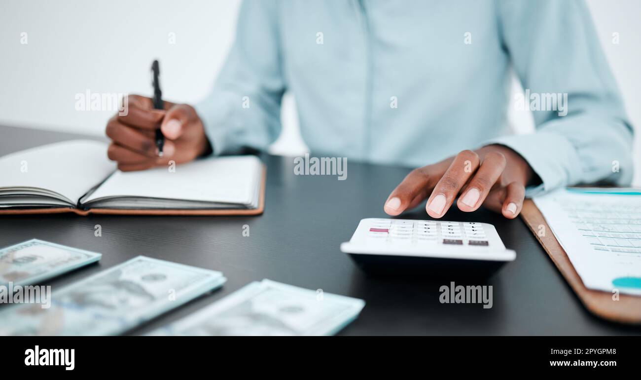 Hand, calculator and writing with a finance accountant working on savings or investment in a work office. Money, accounting and budget with a bank employee at work for financial growth or planning Stock Photo