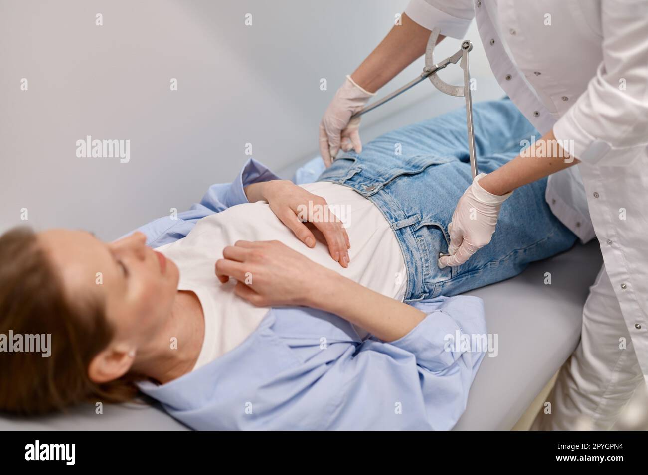 Gynecologist doctor measuring female patient hip volume during checkup Stock Photo