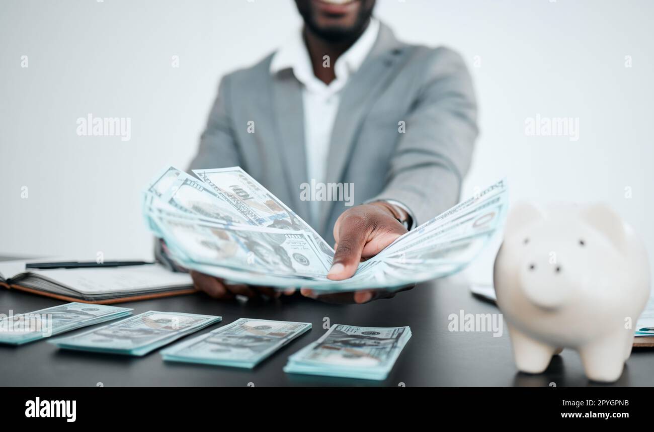 Hand, dollars and businessman with money for bribe in office. Finance, currency and black man offering cash for financial investment, payment or banking, deal or savings, loan or money laundering. Stock Photo