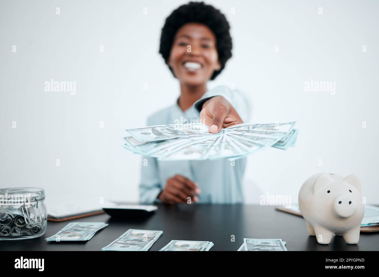 Hand, dollars and black woman with money for payment, financial investment or bribe in office. Portrait, finance or business woman offering cash for banking, deal or savings, loan or money laundering Stock Photo