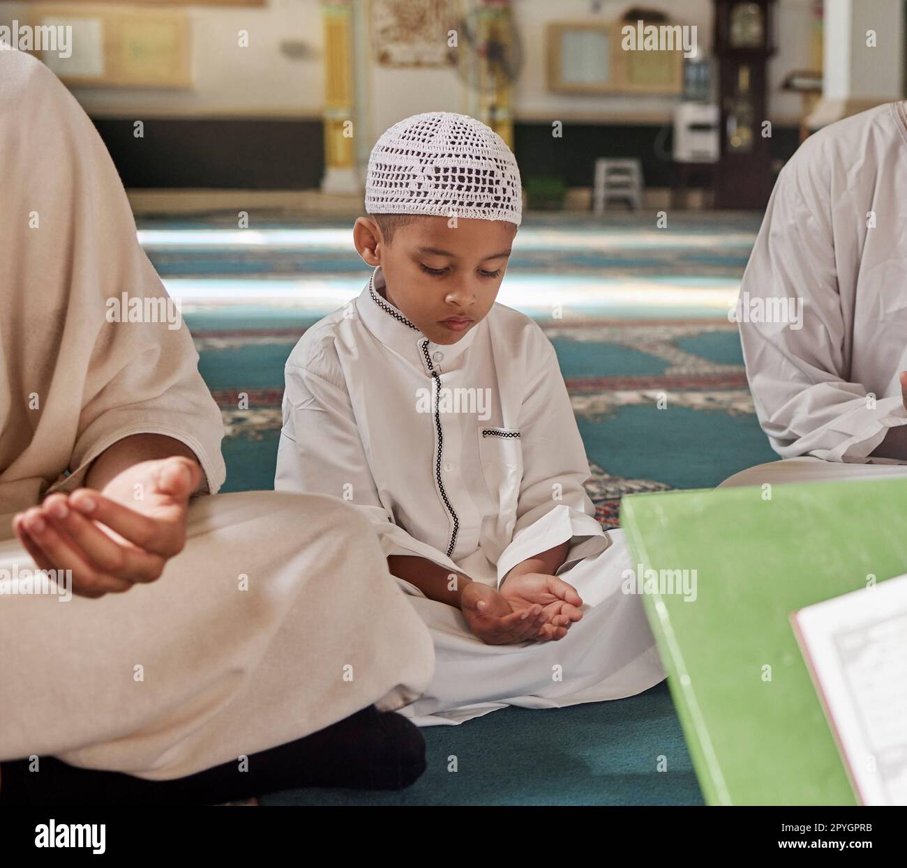Muslim, child or men prayer to worship Allah in holy temple or mosque with gratitude as a family on Ramadan. Islamic, community or people in praying with boy or kid for Gods support, spiritual peace Stock Photo
