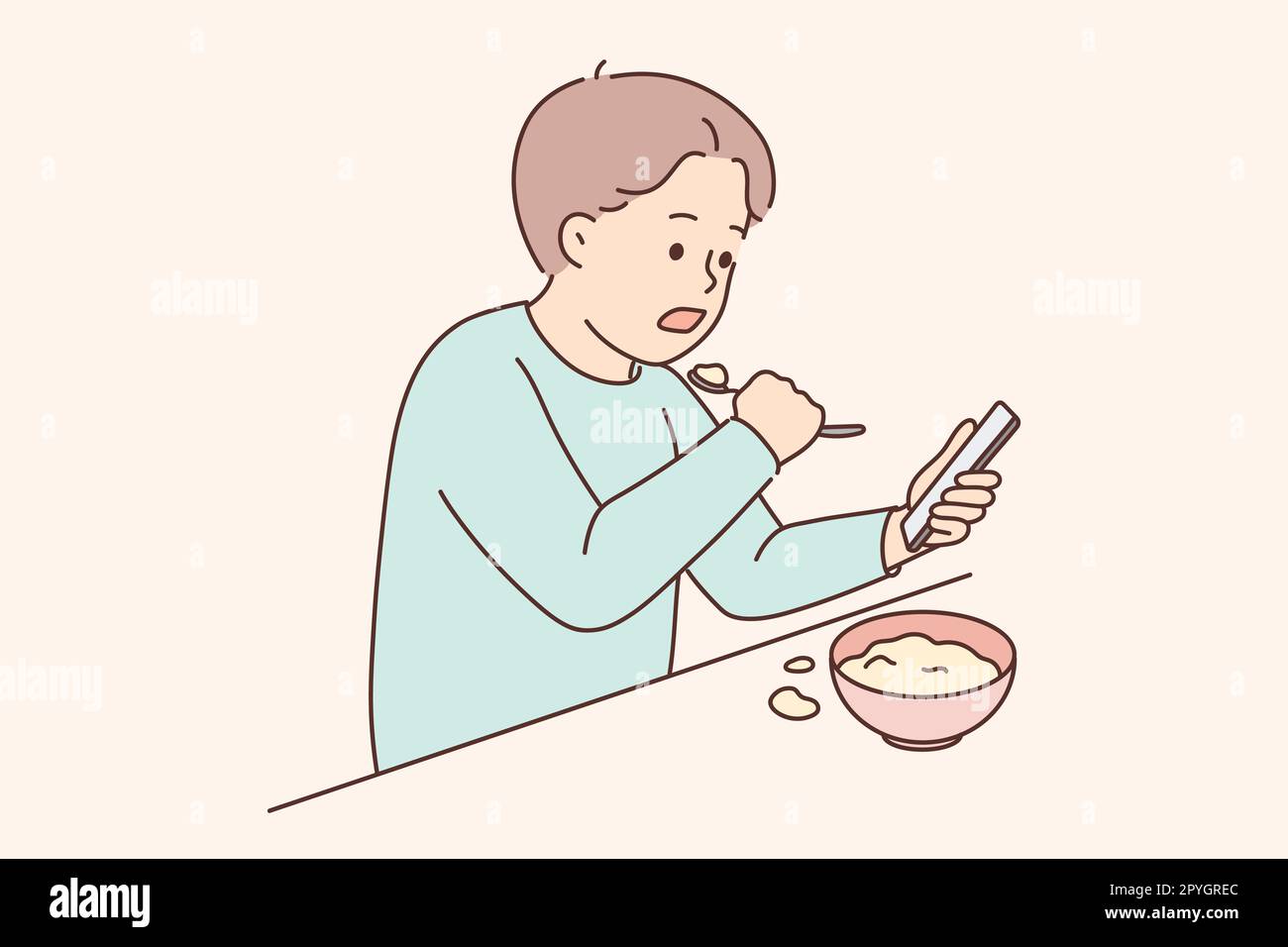 Little child sit at table eating watching cartoons on cellphone. Small boy kid with food at home involved in game on smartphone. Children and technolo Stock Photo
