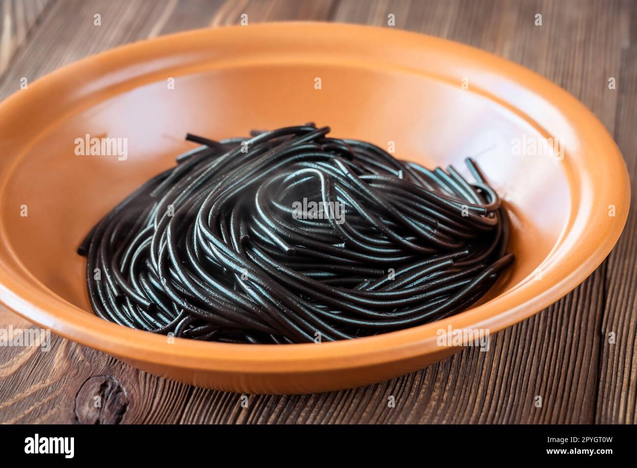 Portion of black squid ink spaghetti pasta Stock Photo - Alamy