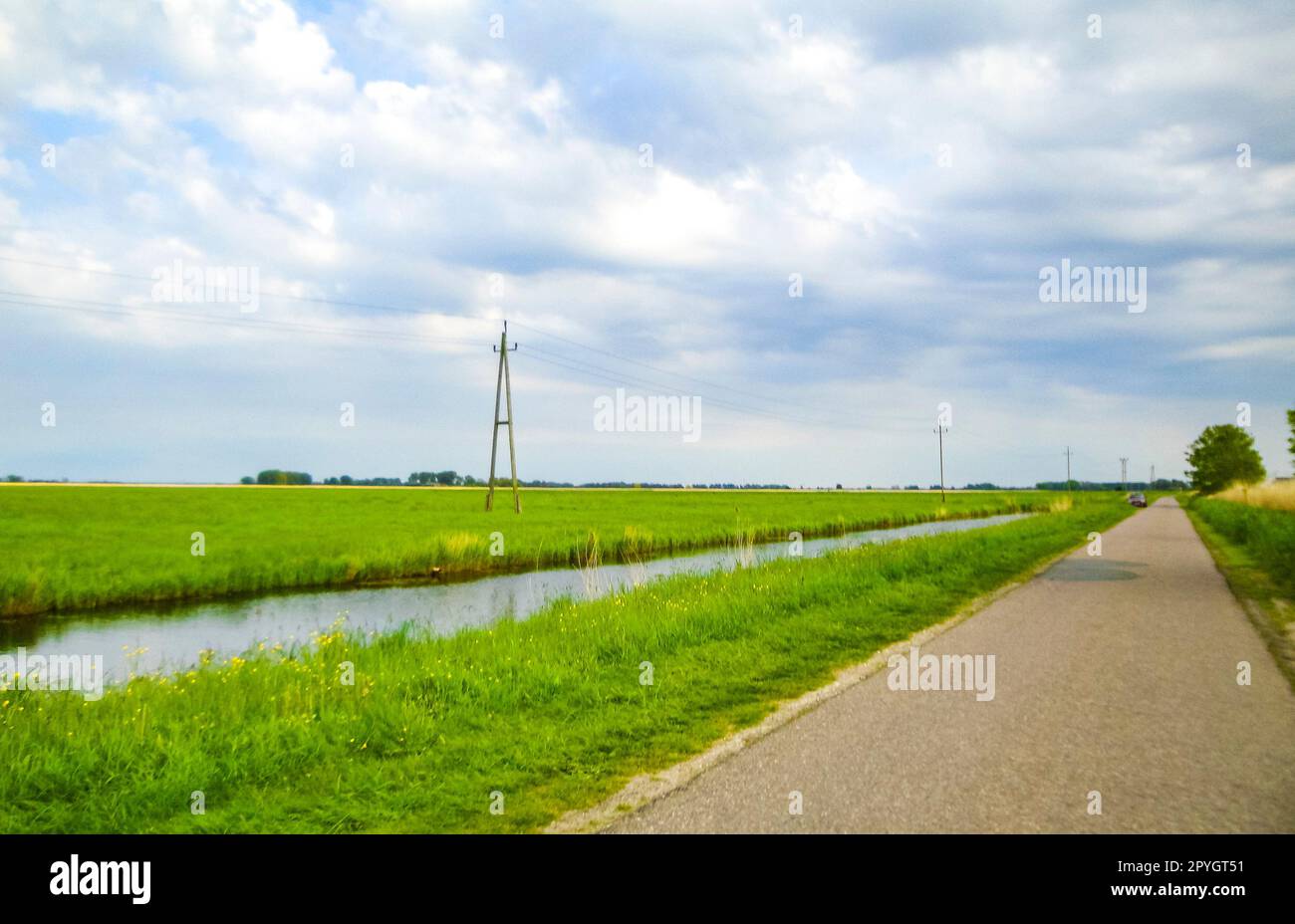 Road through nature with fields and streams in Germany. Stock Photo