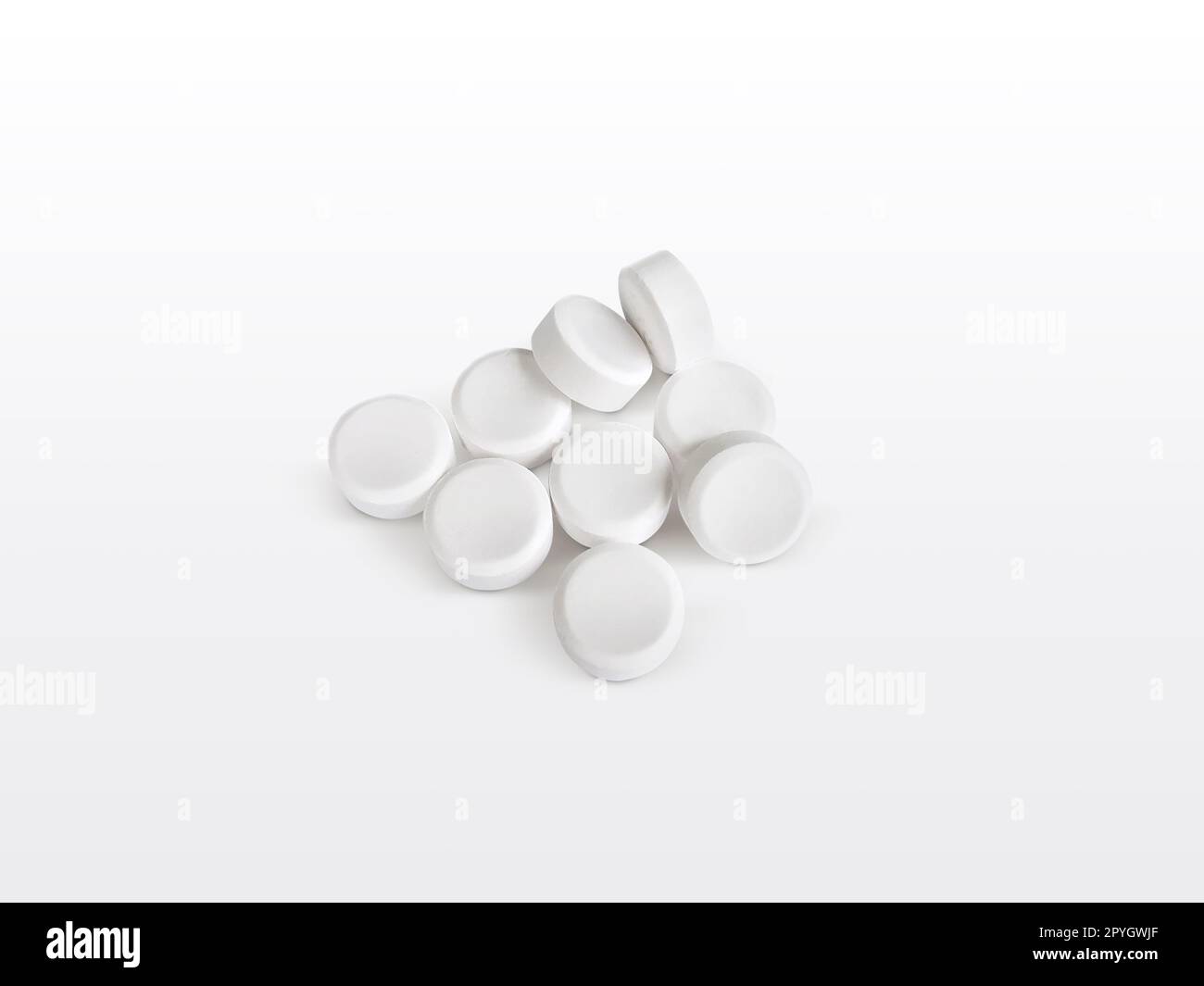 Heap of white painkiller tablets on white Stock Photo