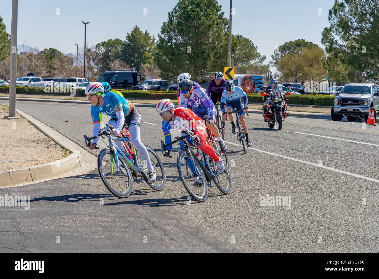 Victorville, CA, USA – March 26, 2023: Men’s cycling road race turning a corner in an event held by Majestic Cycling in Victorville, California. Stock Photo