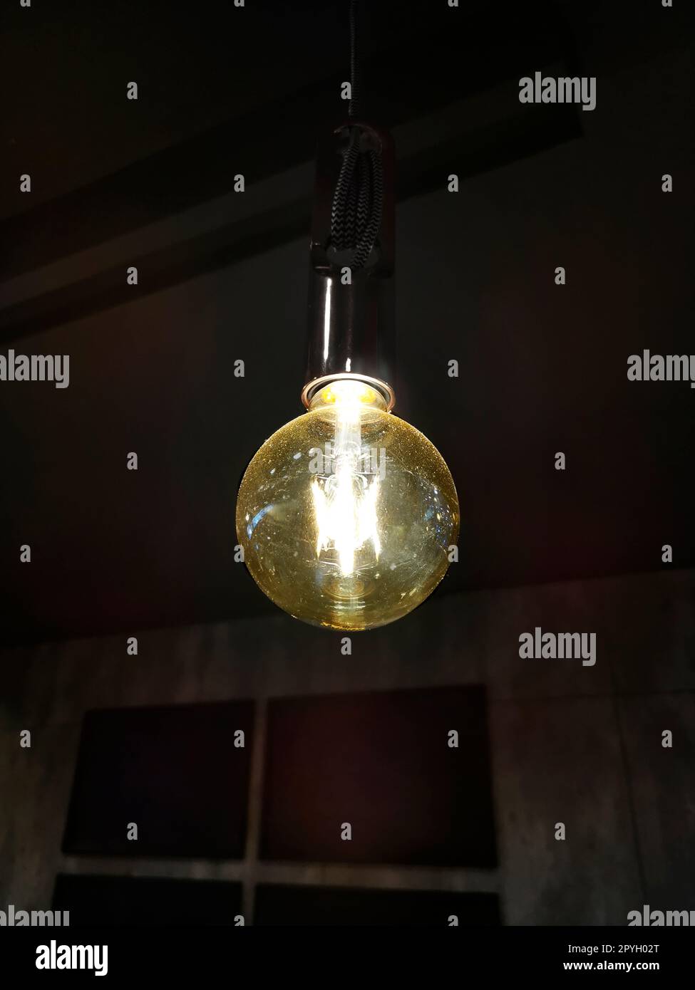 light bulb glowing in dark Stock Photo