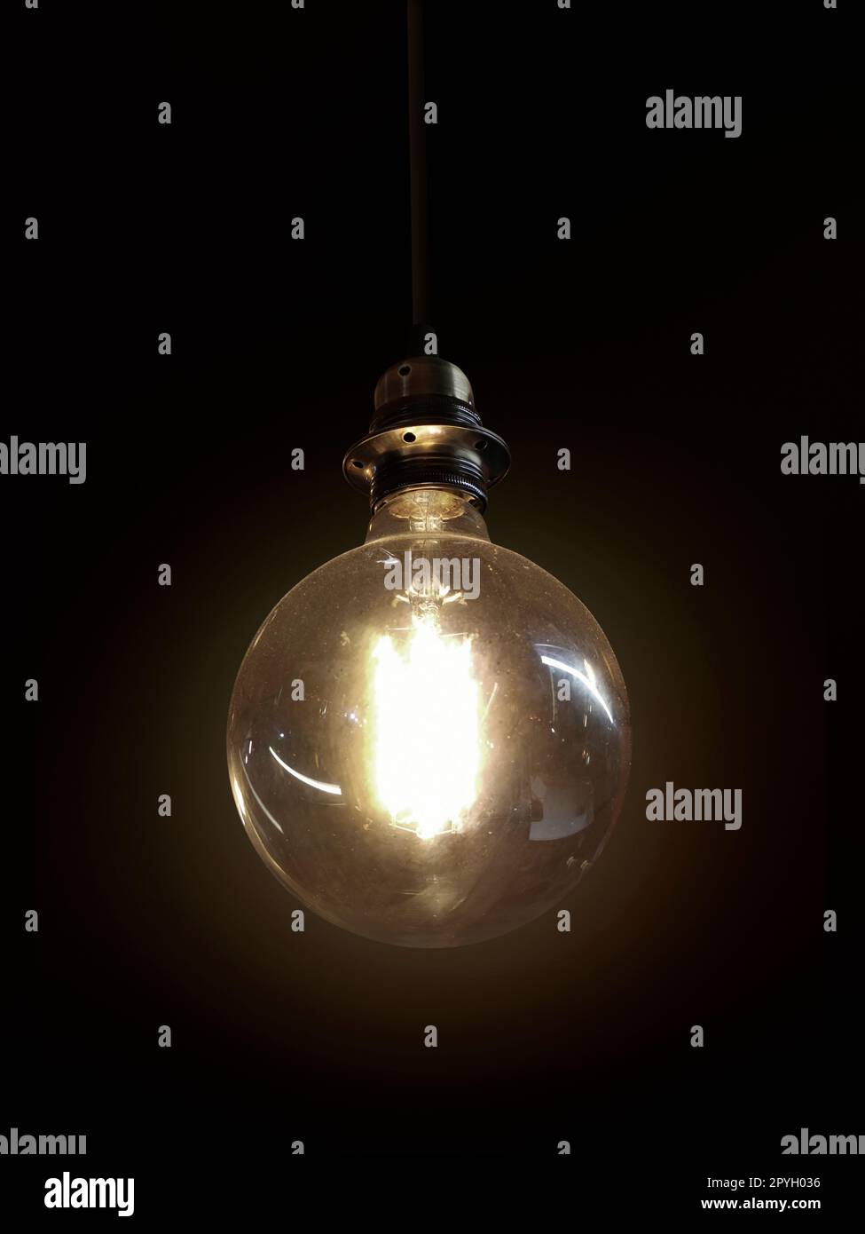 Glowing light bulb on dark background Stock Photo