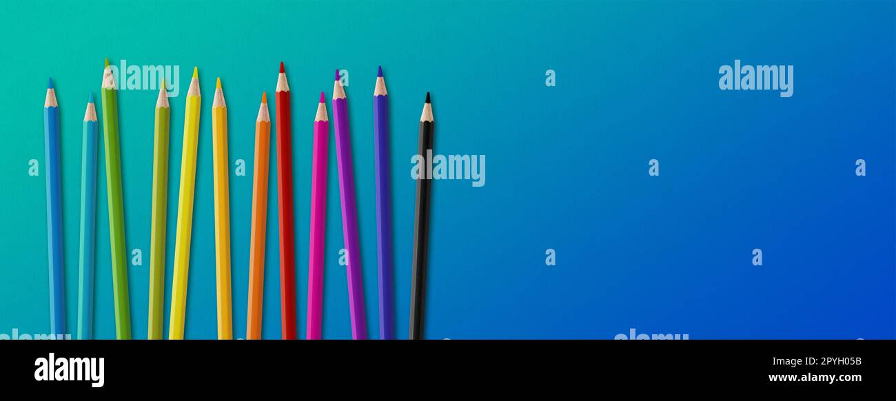 Colored pencil group isolated on blue. Panoramic banner background Stock Photo