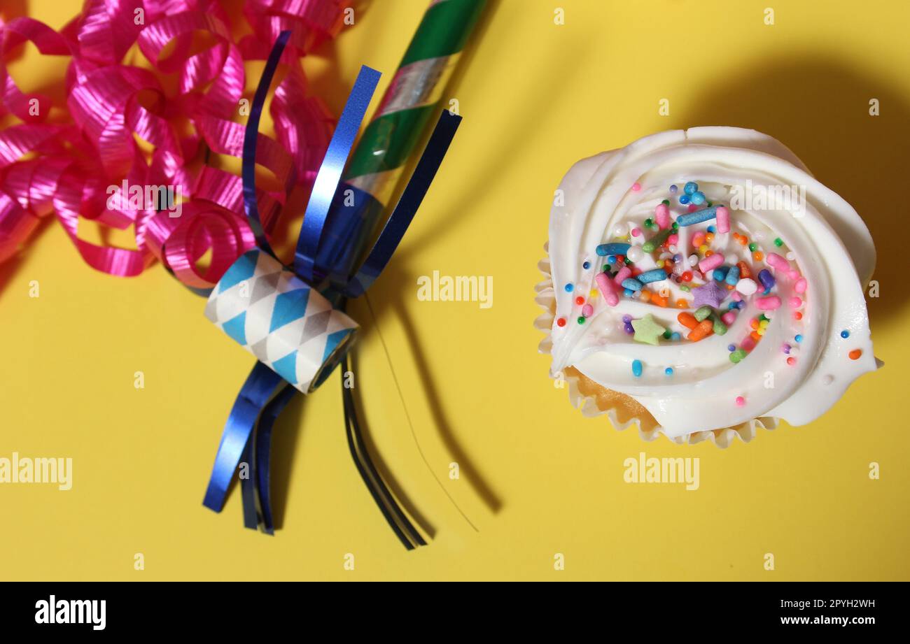 Cupcakes on Table at Party on Yellow Table Stock Photo