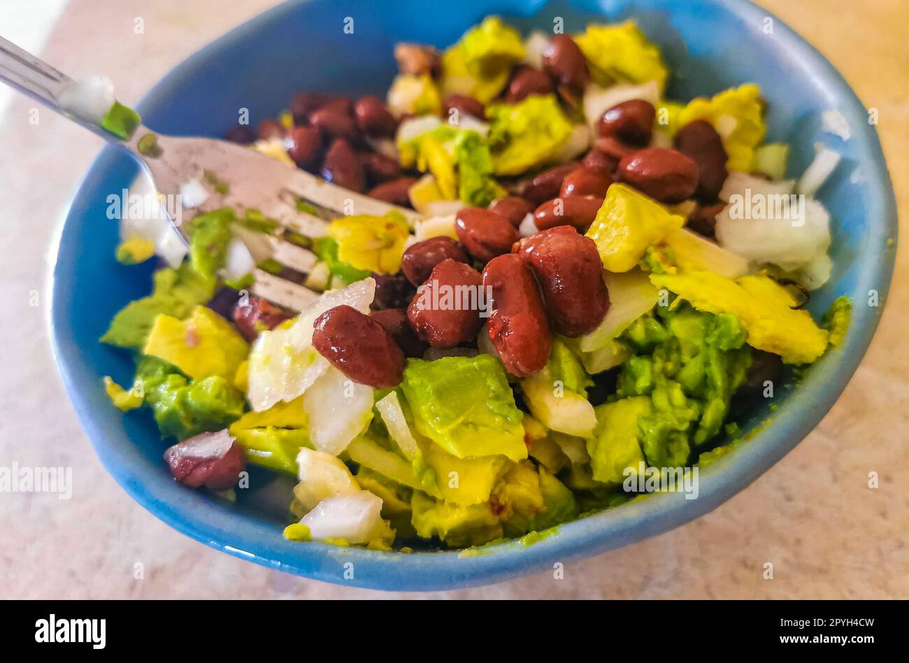 Homemade bean avocado and onion salad in blue bowl Mexico Stock Photo Alamy