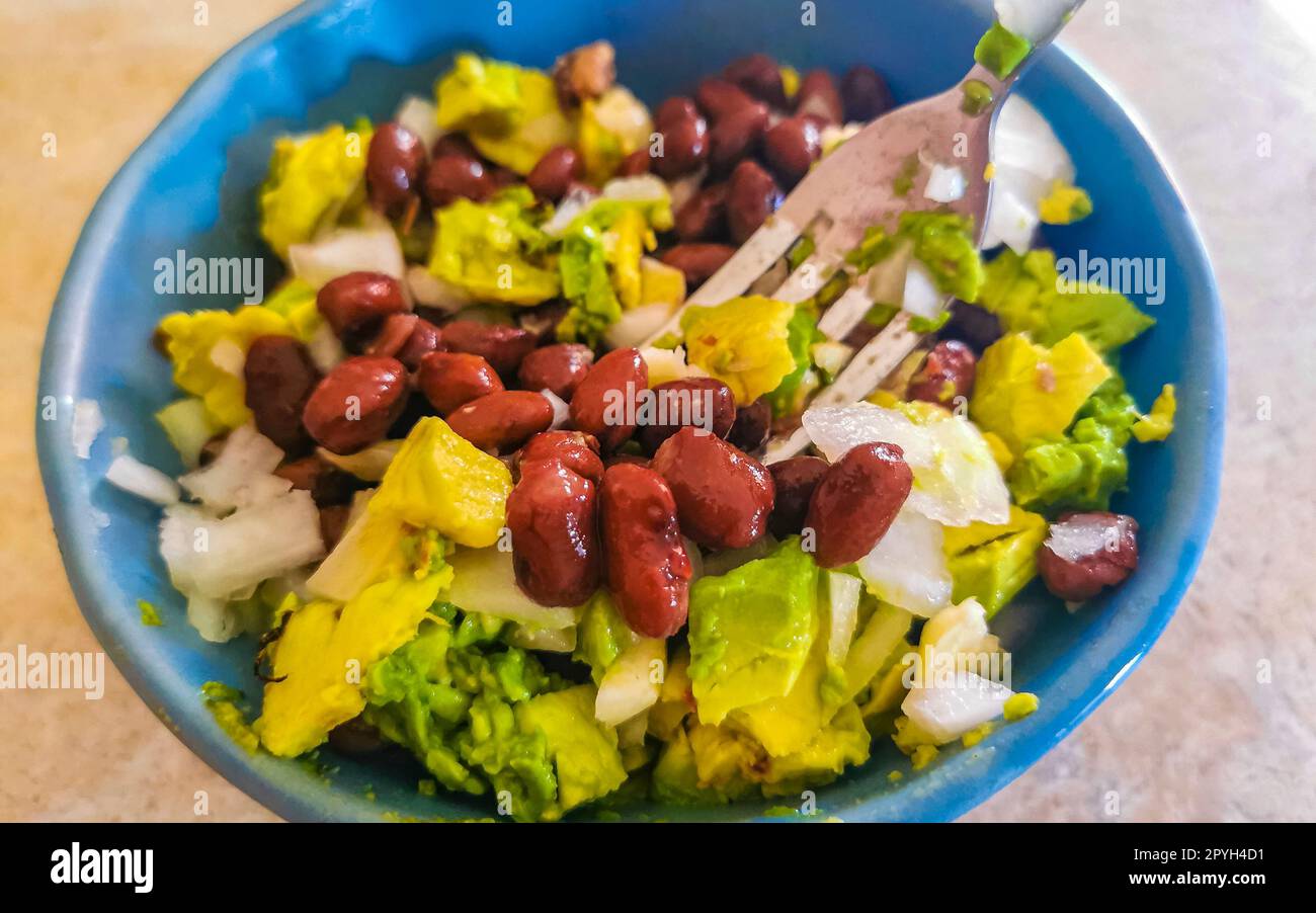 Homemade bean avocado and onion salad in blue bowl Mexico Stock Photo Alamy
