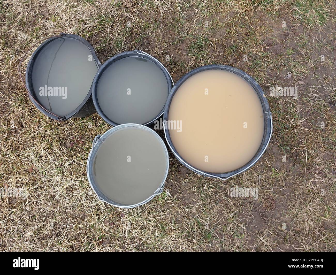Cleaning a drinking well from silt water in a bucket Stock Photo