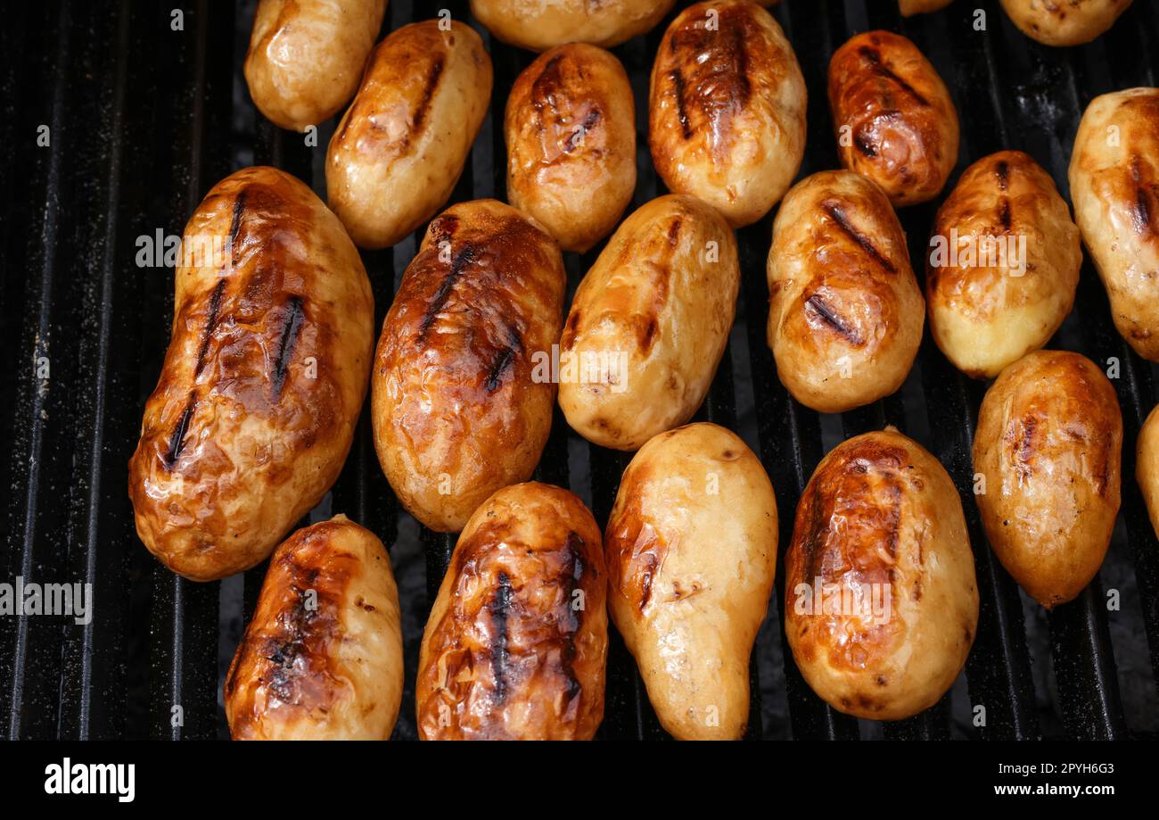 Cooking new potato in charcoal grill Stock Photo Alamy
