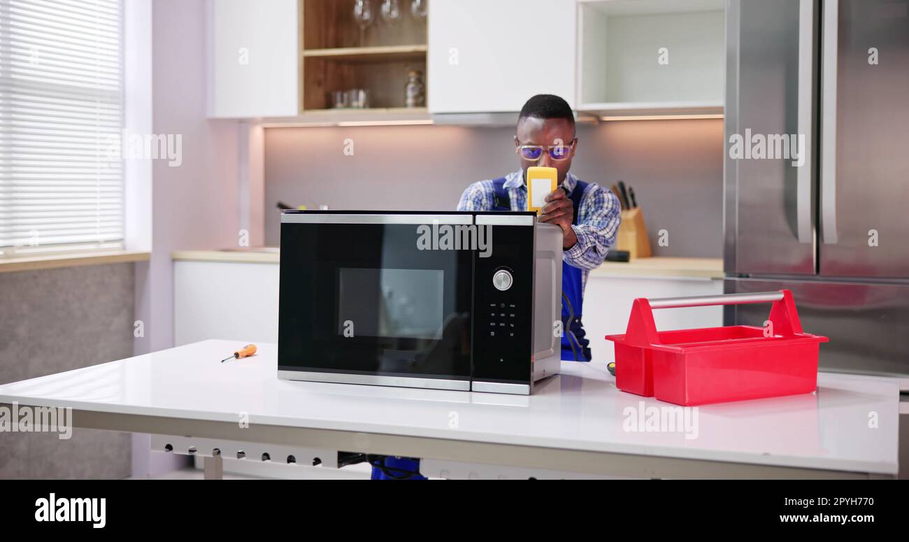 Repair Microwave Fix Appliance Technician Domestic Stock Photo - Alamy