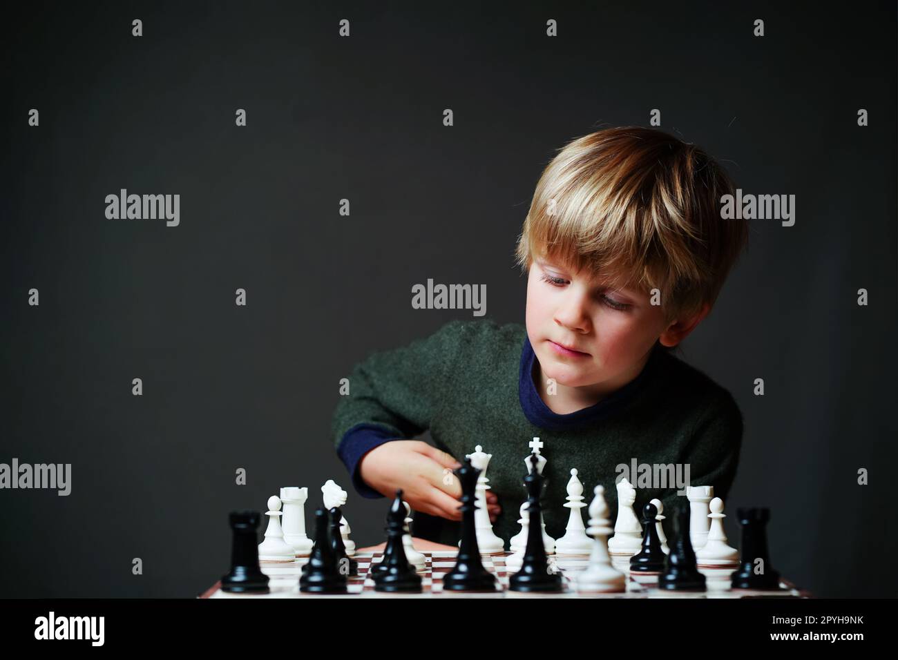 Premium Photo  Portrait of child during chess game boy plays chess and  thinks intently about the next move isolation on white background