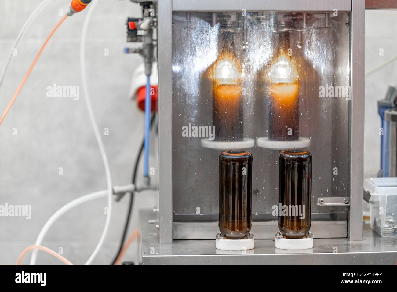 machine for automatic filling of beer bottles in a brewery Stock Photo