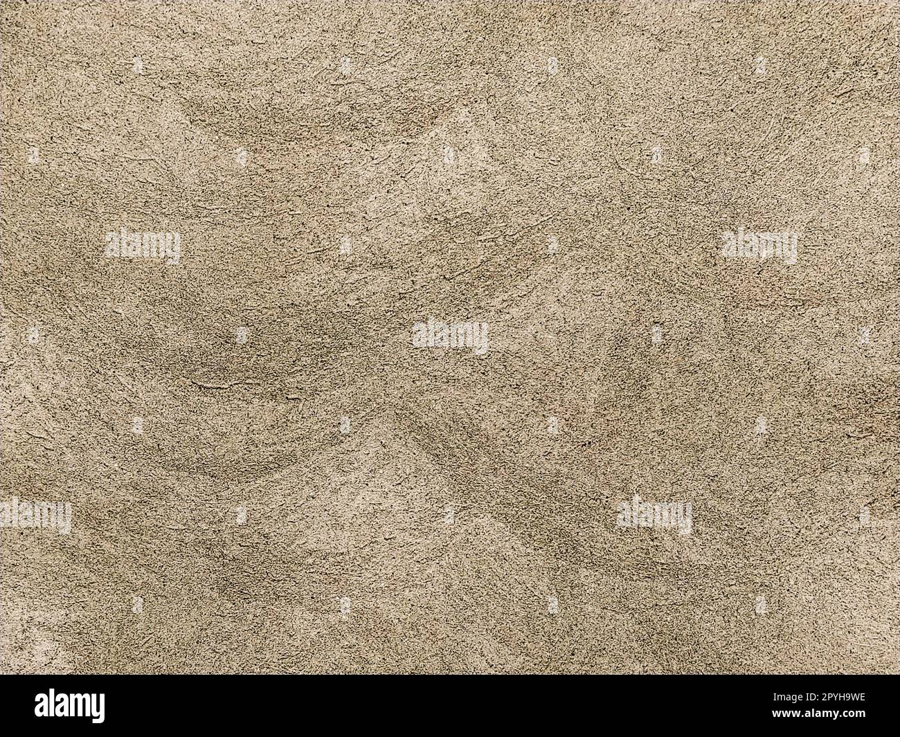Concrete surface with multi-colored blotches of small stones. Light beige tone. Wall of a building or concrete slab. Close-up. Pockmarked cement surface. Interior or exterior finish option Stock Photo