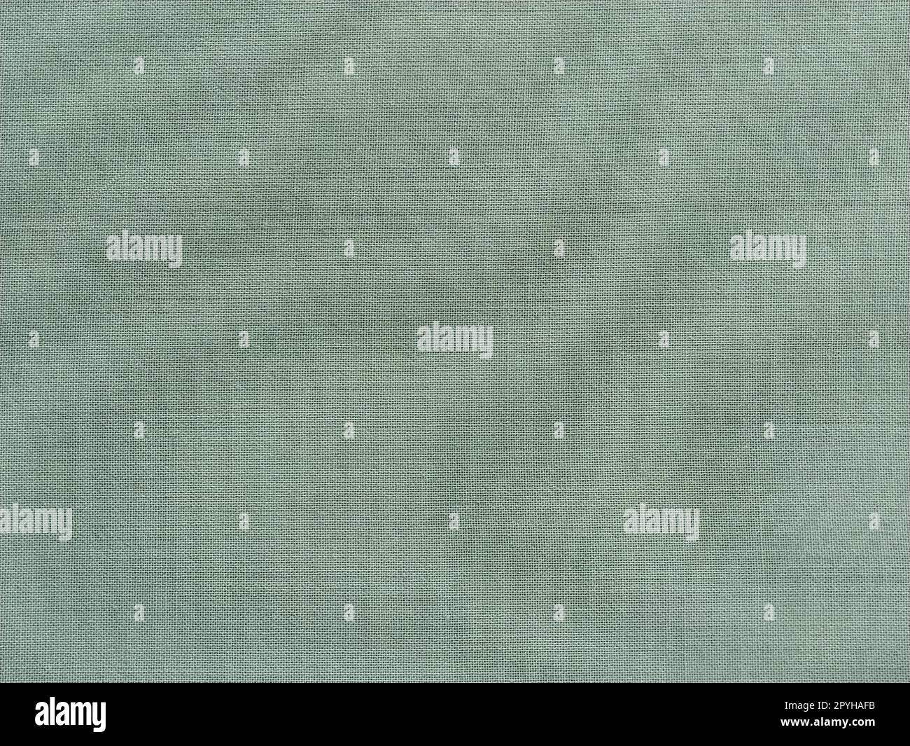 light green fabric. A piece of woolen fabric laid out neatly on the surface. Interlacing and textile texture. dress fabric or for kitchen needs, tablecloth or curtains Stock Photo