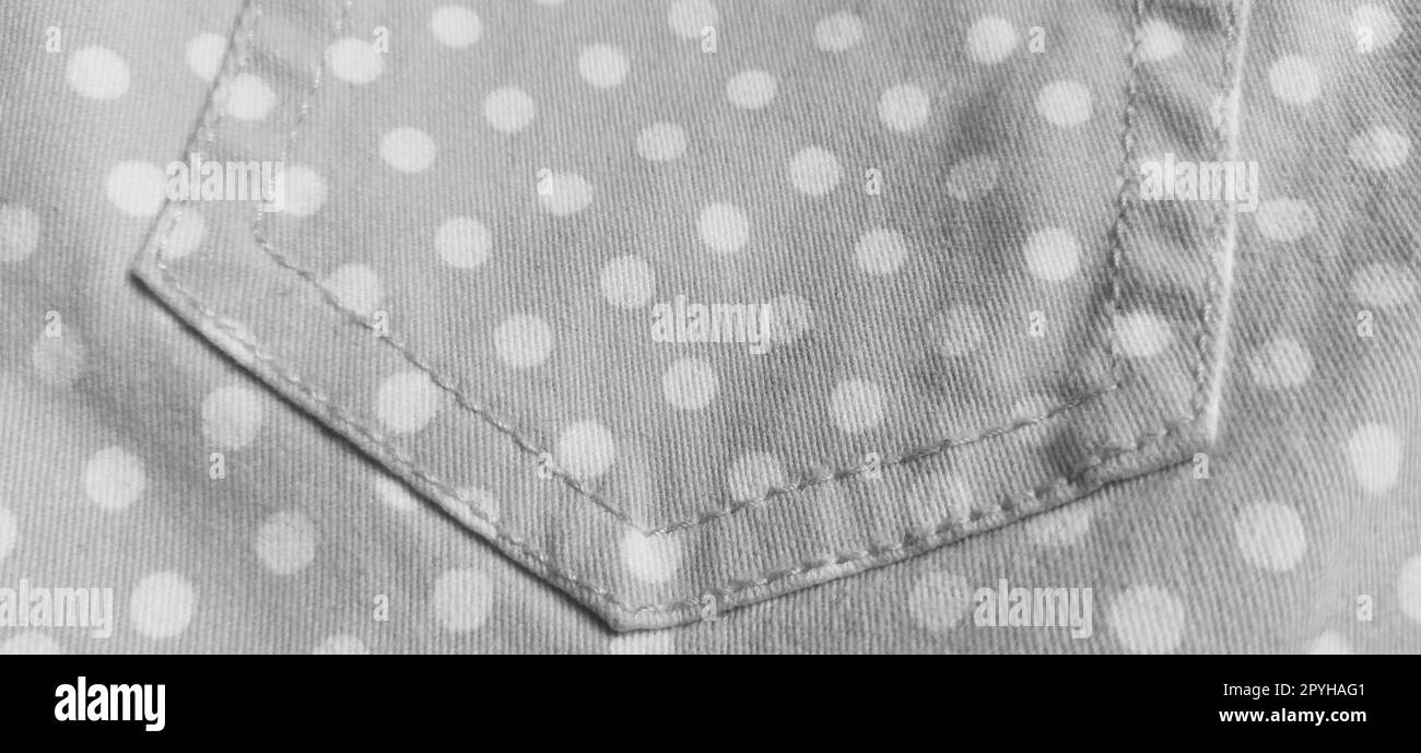 Belgrade, Serbia, 11 September 2020 Trouser pocket. Denim cloth with white circles. Pockets on denim. Polka dot fabric. Black and white monochrome image Stock Photo