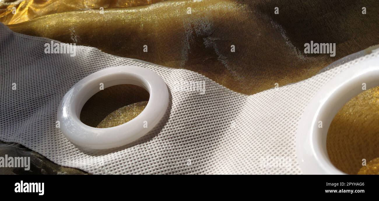 Plastic rings for attaching the fabric to the curtain rod. White