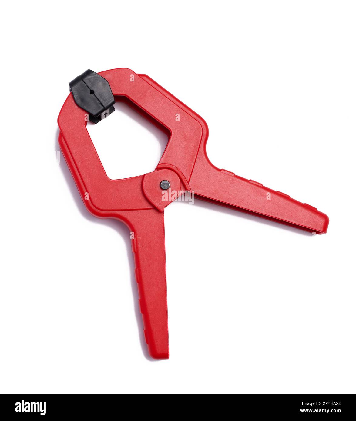 Large  red plastic clamp on a white isolated background Stock Photo