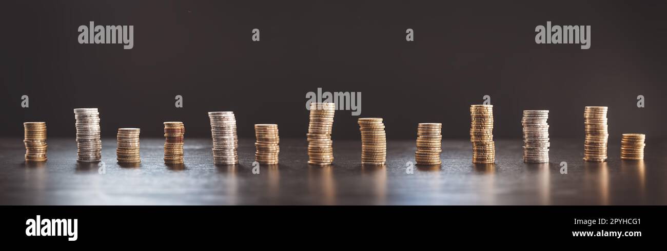 Towers of the coins on the black background. Stock Photo