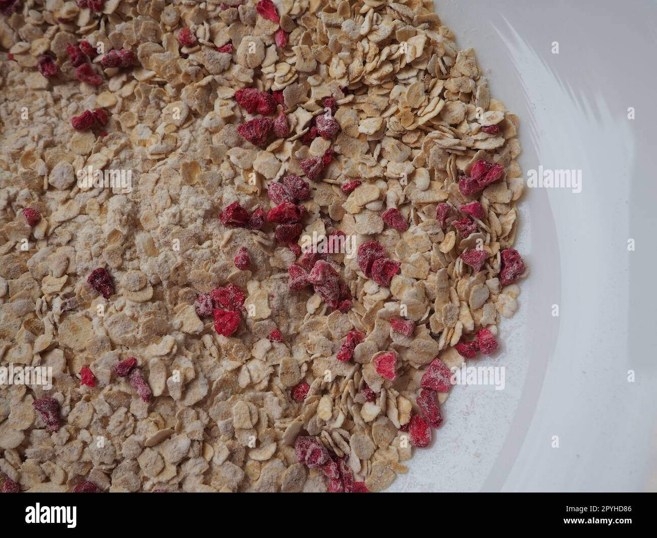 Organic Granola Cereal with oats, powdered sugar and dry raspberries