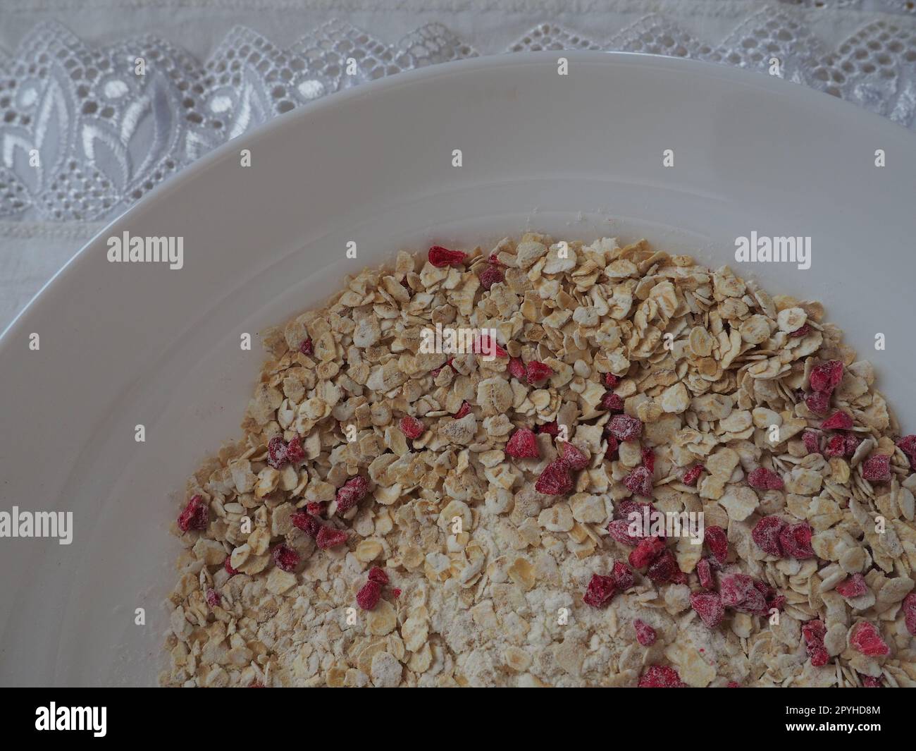 Organic Granola Cereal with oats, powdered sugar and dry raspberries. Healthy muesli as a dry