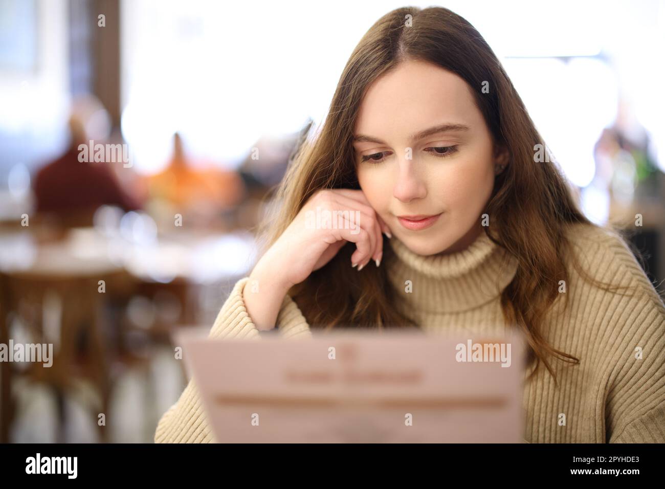 Woman reading menu in a restaurant Stock Photo - Alamy