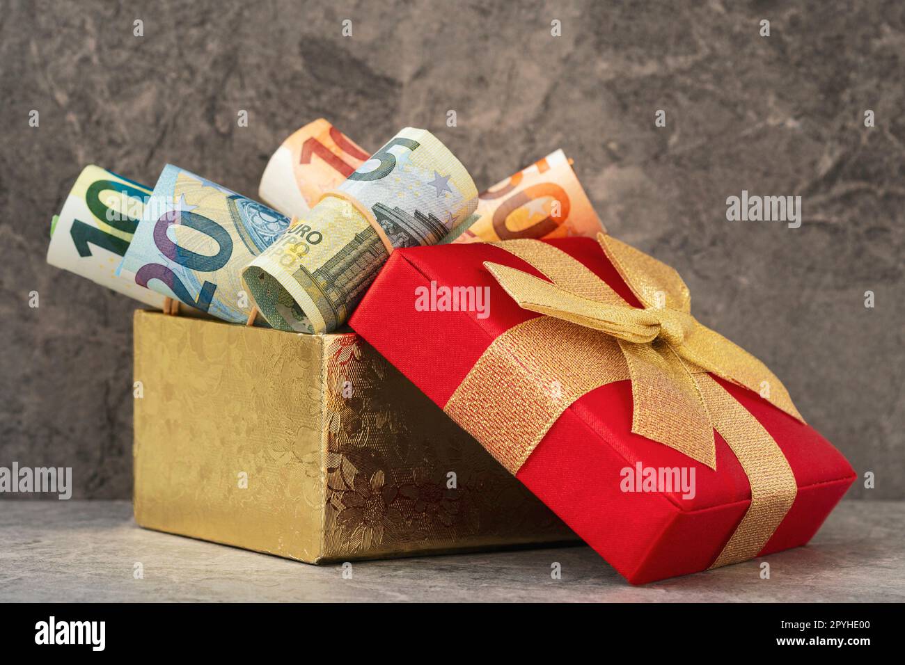 Pile of rolled up Euro banknotes in a present box Stock Photo