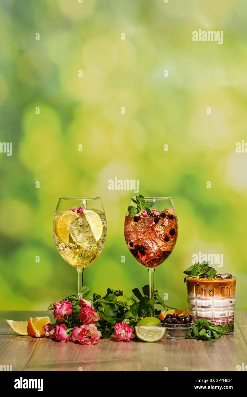 Set of cold sangria and iced coffee summer drinks on wooden table with ingredients Stock Photo