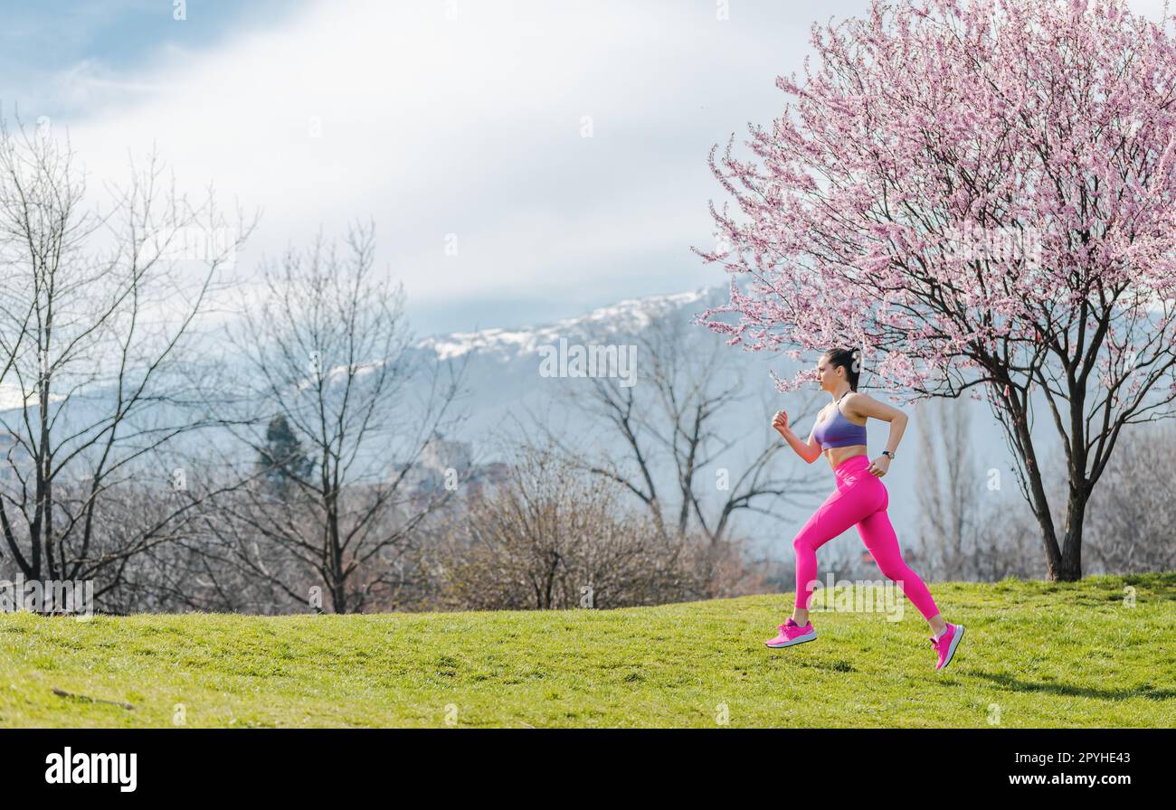 Woman running for fitness on a spring day Stock Photo