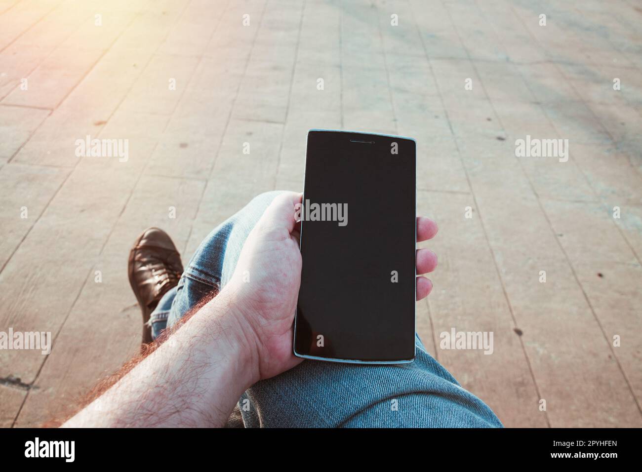 Man using the smartphone outdoors Stock Photo
