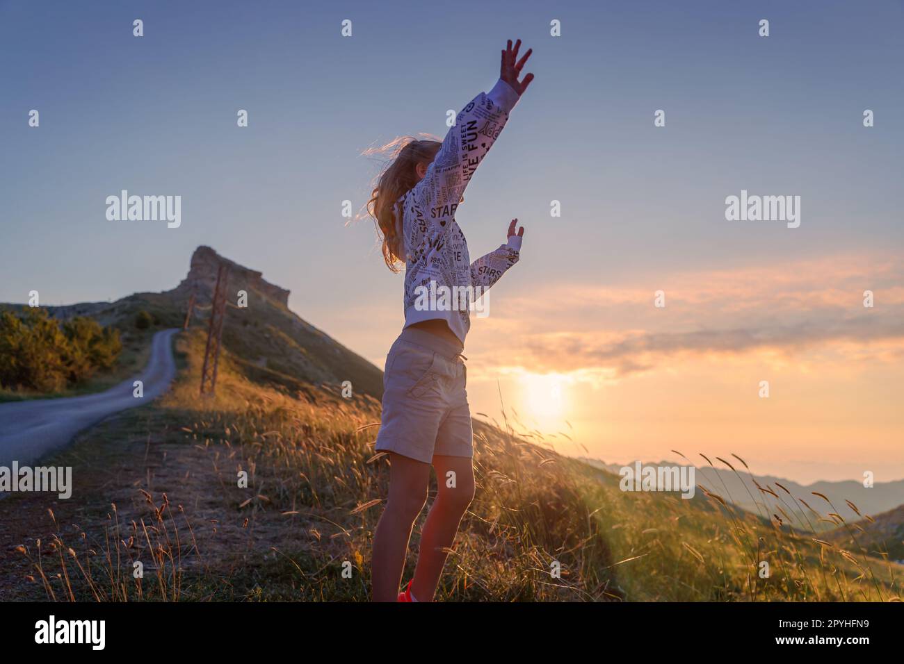 Teen girl enjoying nature of mountains Stock Photo