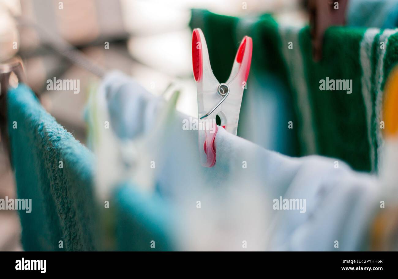 Laundry pins on ropes at home Stock Photo